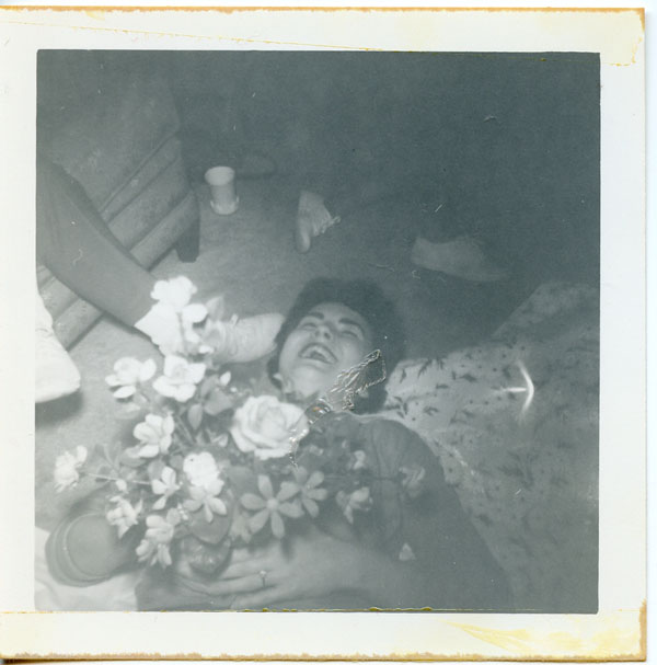 Suzanne Stratman on the ground with bouquet, 1961
